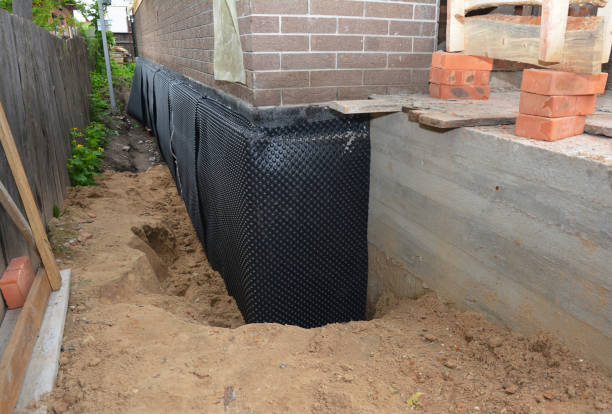 SJ Waterproofing Pros technician performing targeted Waterproofing assessment in DeWitt, MI